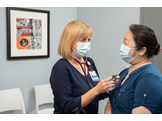 A nurse meets with a patient at LG Healthworks